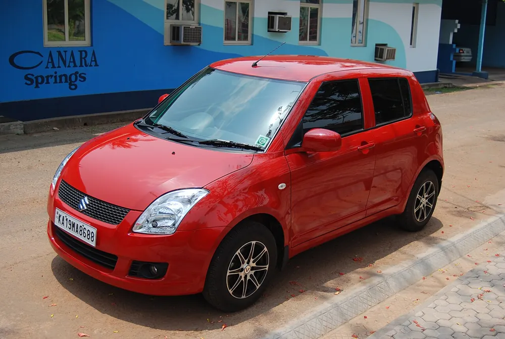 Red Maruti Suzuki Swift hatchback
