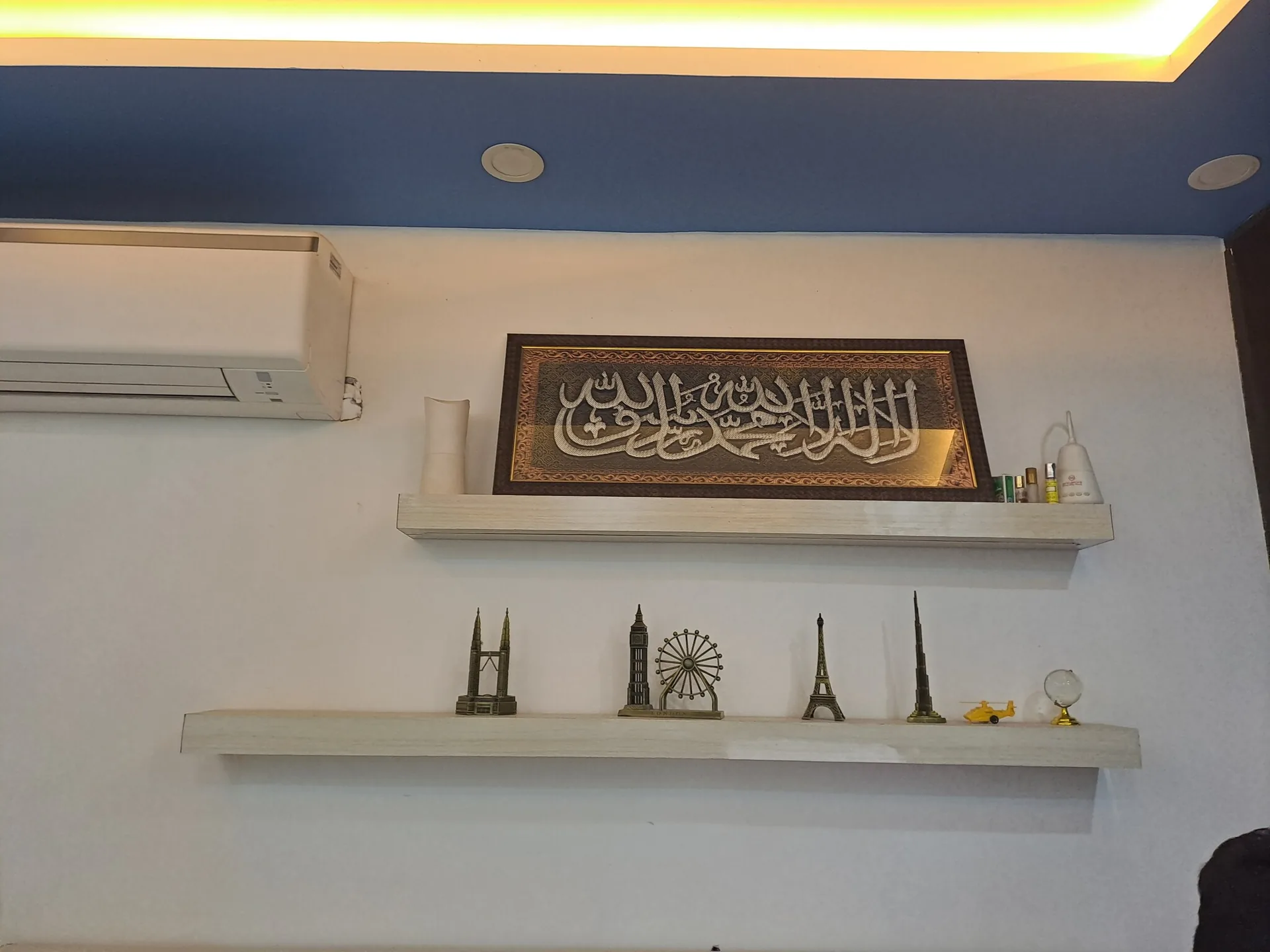 Inside the Travel Point office with Islamic calligraphy on the wall