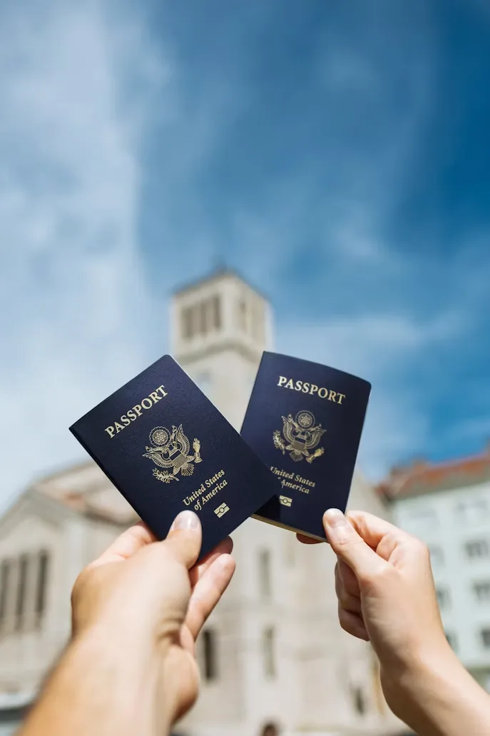 Traveller holding two passports ready for a visa application